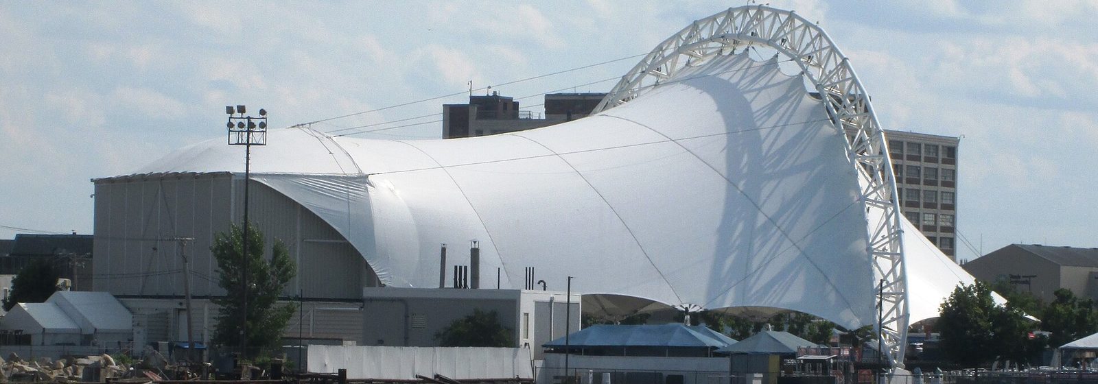 The white tensile canopy of Leader Bank Pavilion, the outdoor amphitheater in Boston's Seaport District, viewed from Boston Harbor - Leader Bank Pavilion tickets