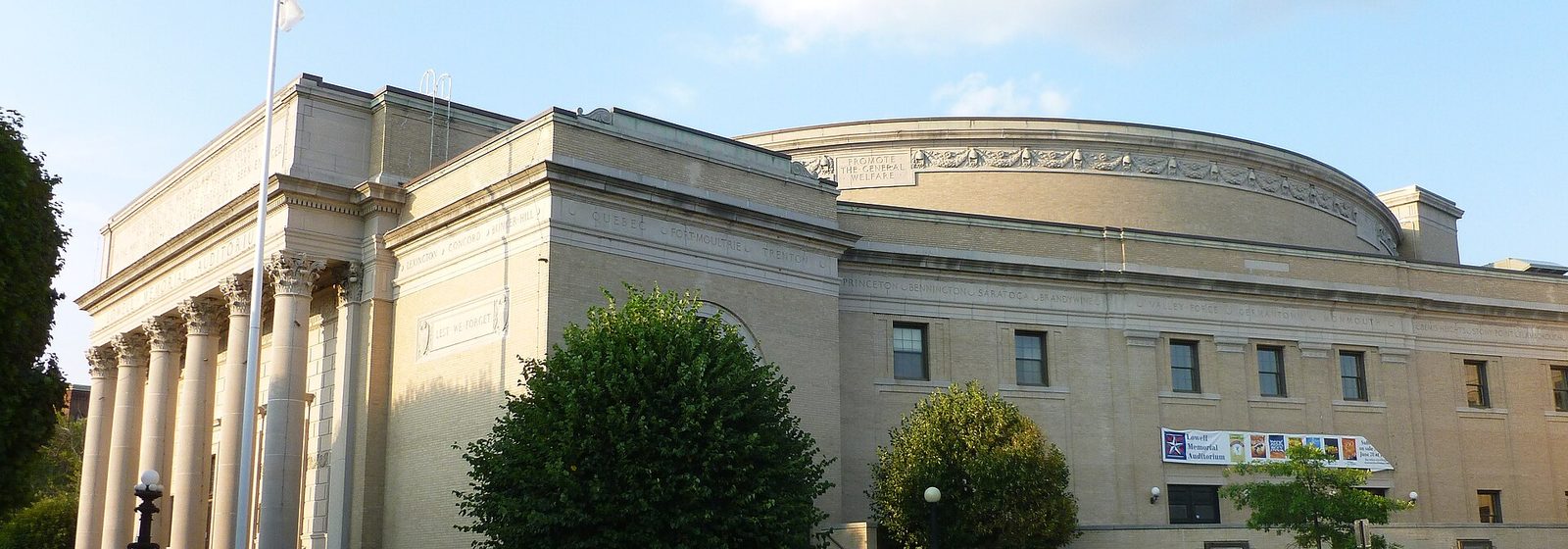 Street-level exterior view of the columned neoclassical facade of Lowell Memorial Auditorium on East Merrimack Street in Lowell, Massachusetts - Lowell Memorial Auditorium tickets