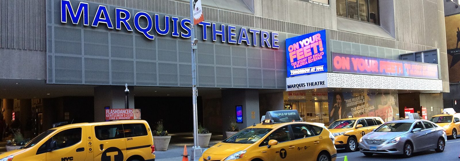 Daytime view of the marquee and street-level facade of the Marquis Theatre on West 46th Street in Manhattan, New York - Marquis Theatre - NY tickets