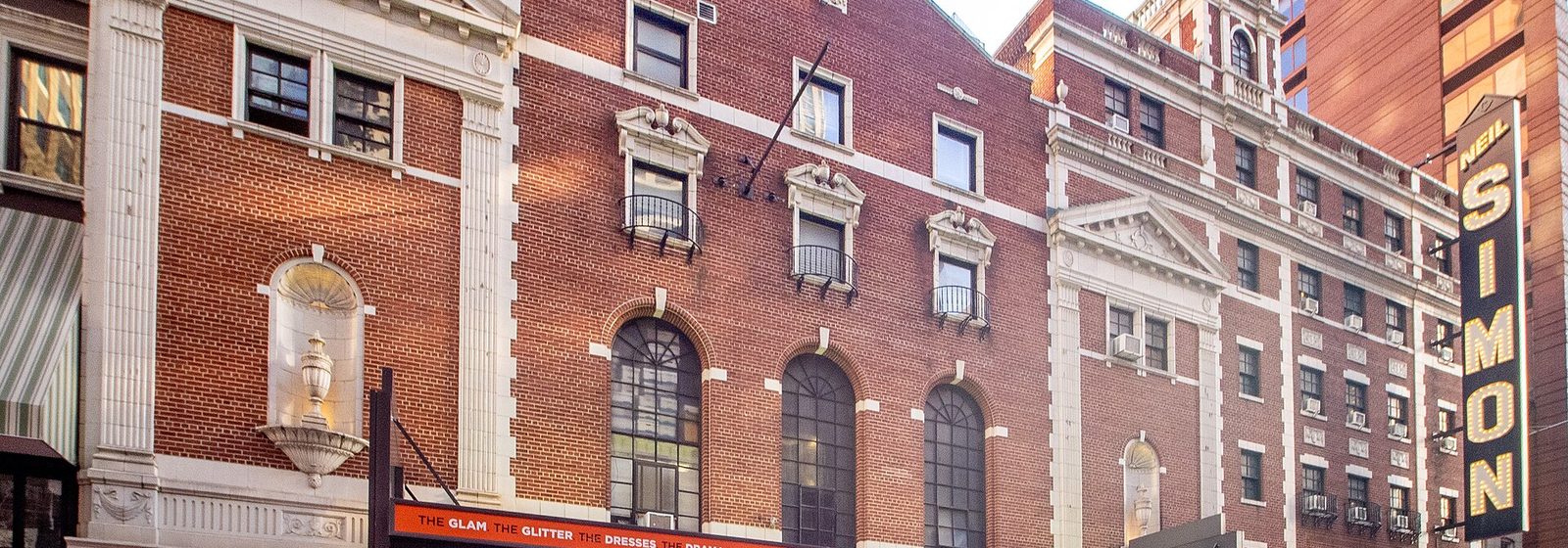 Street-level view of the brick and terra-cotta facade of the Neil Simon Theatre on West 52nd Street in Manhattan, New York City, with its vertical Neil Simon sign at right - Neil Simon Theatre tickets