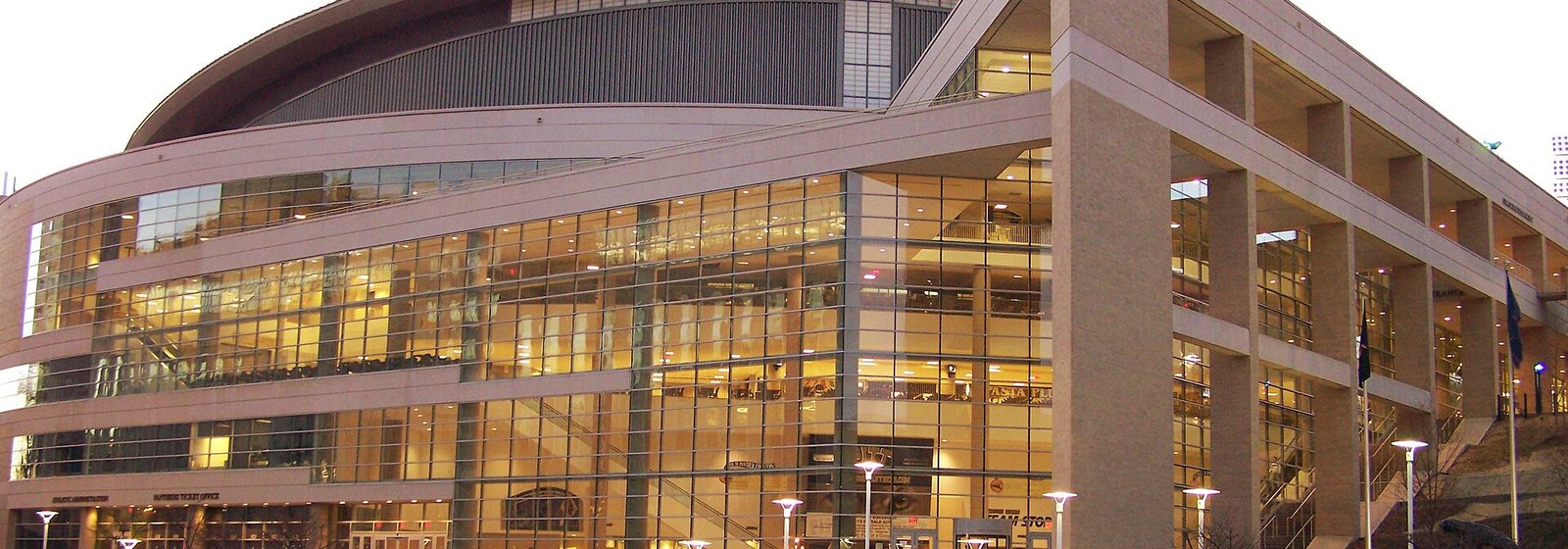 Glass facade and entrance stairs of the Petersen Events Center at the University of Pittsburgh at dusk - Petersen Events Center tickets