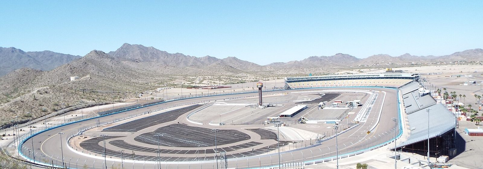 Elevated view of the Phoenix Raceway track and grandstands from the summit of Monument Hill in Avondale, Arizona - Phoenix Raceway tickets