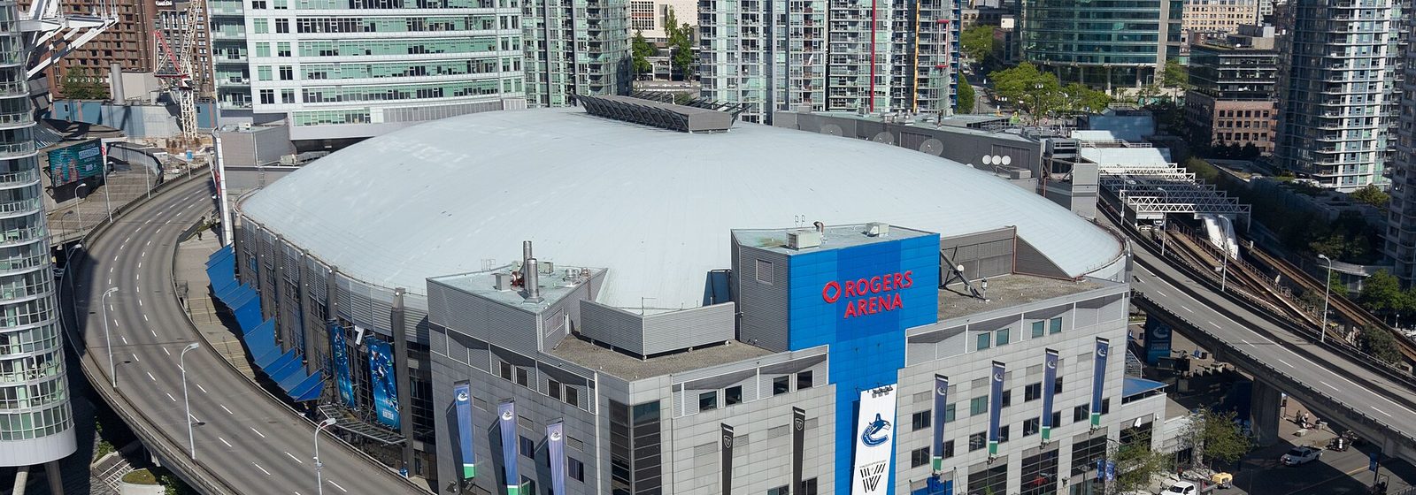 Aerial view of Rogers Arena and its white domed roof surrounded by high-rise towers in downtown Vancouver - Rogers Arena tickets