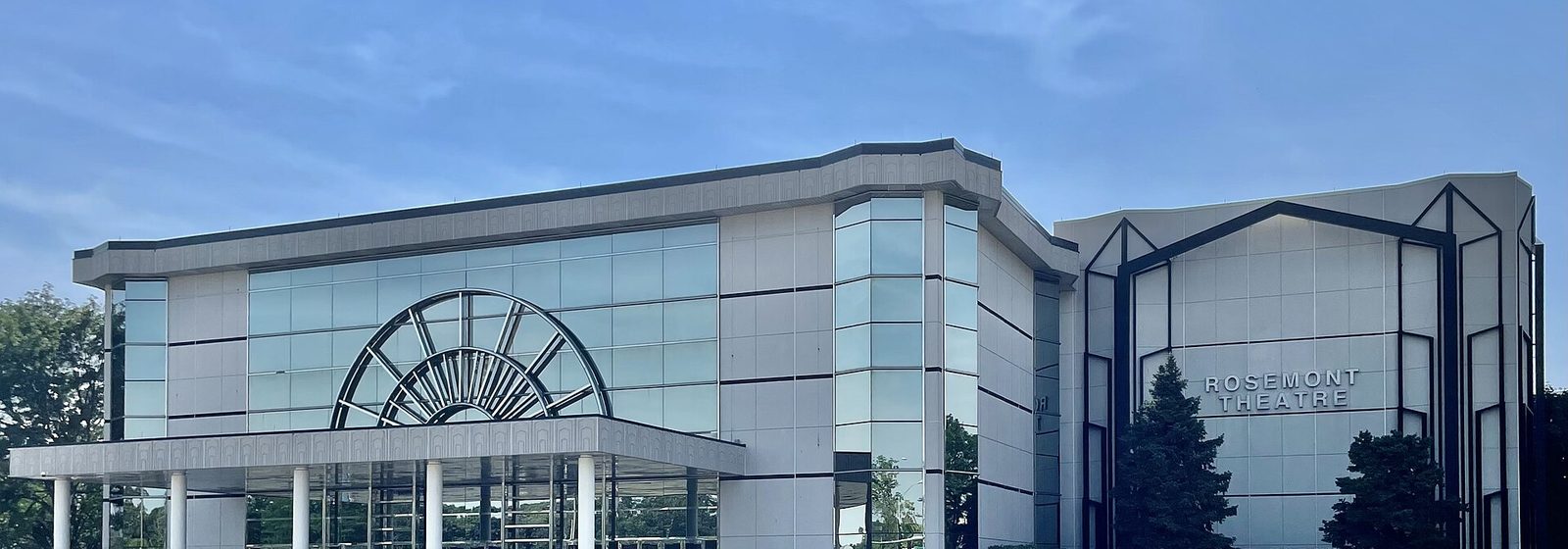 Exterior facade of the Rosemont Theatre in Rosemont, Illinois, with its fan-shaped glass window above the columned entrance canopy - Rosemont Theatre tickets