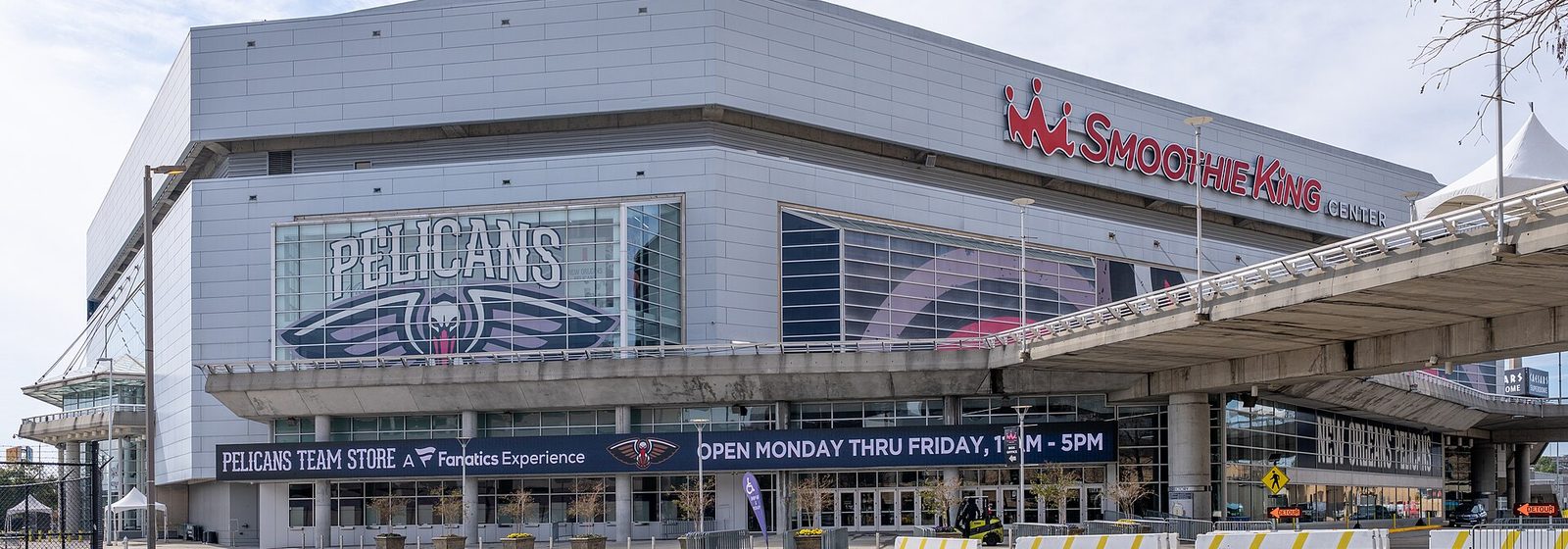 Street-level exterior view of the Smoothie King Center arena in New Orleans, with the venue's signage on the facade - Smoothie King Center tickets
