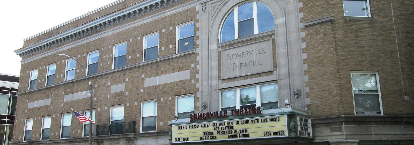 Street-level view of the Somerville Theatre's brick facade and marquee in the Hobbs Building at Davis Square in Somerville, Massachusetts - Somerville Theatre tickets