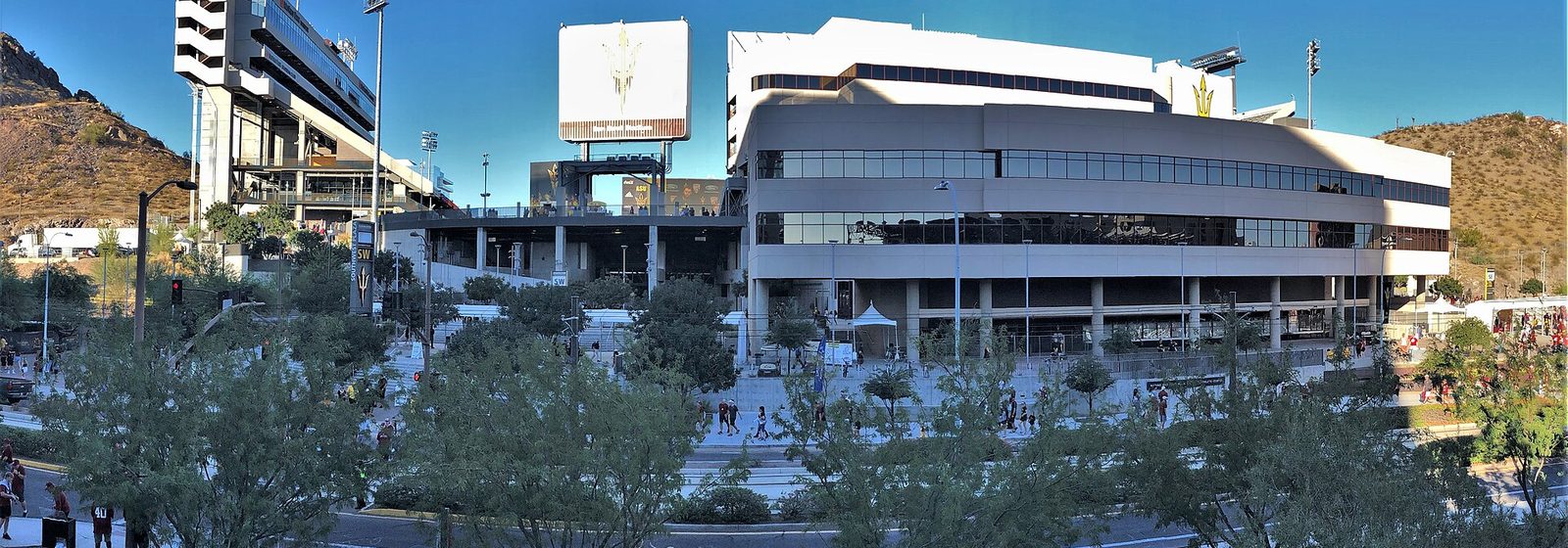 Daytime exterior view of Sun Devil Stadium on the Arizona State University campus in Tempe, Arizona, with the renovated south facade and desert buttes on either side - Sun Devil Stadium tickets