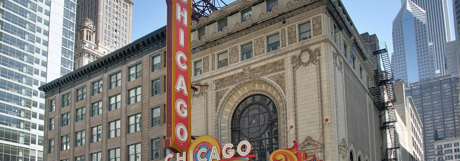 Night view of the Chicago Theatre facade, marquee, and vertical sign on State Street in Chicago, Illinois - The Chicago Theatre tickets